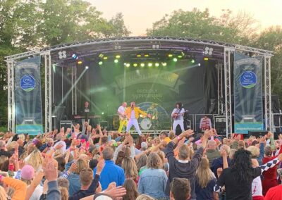 Music By The Lake - Queen Tribute. Arch roof stage hire supplied by Slick Events Ltd. Dorset